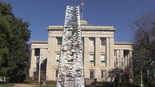 Veterans for Peace members construct a replica of the iconic Memorial Belltower using recycled aluminium cans