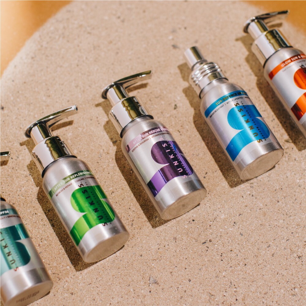 SunKiss products, packaged in aluminium bottles, all for eco-friendly beauty enhancement